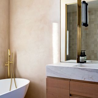 bathroom with brass fittings and oak timber cabinetry
