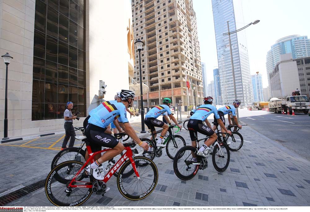 The riders start in the shadows of the Doha skyscrapers