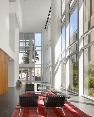 Seating area on a red rug with high ceiling