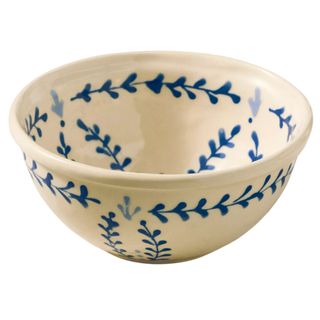 A cream bowl with blue patterned detailing