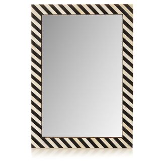rectangular mirror with a black and white striped frame