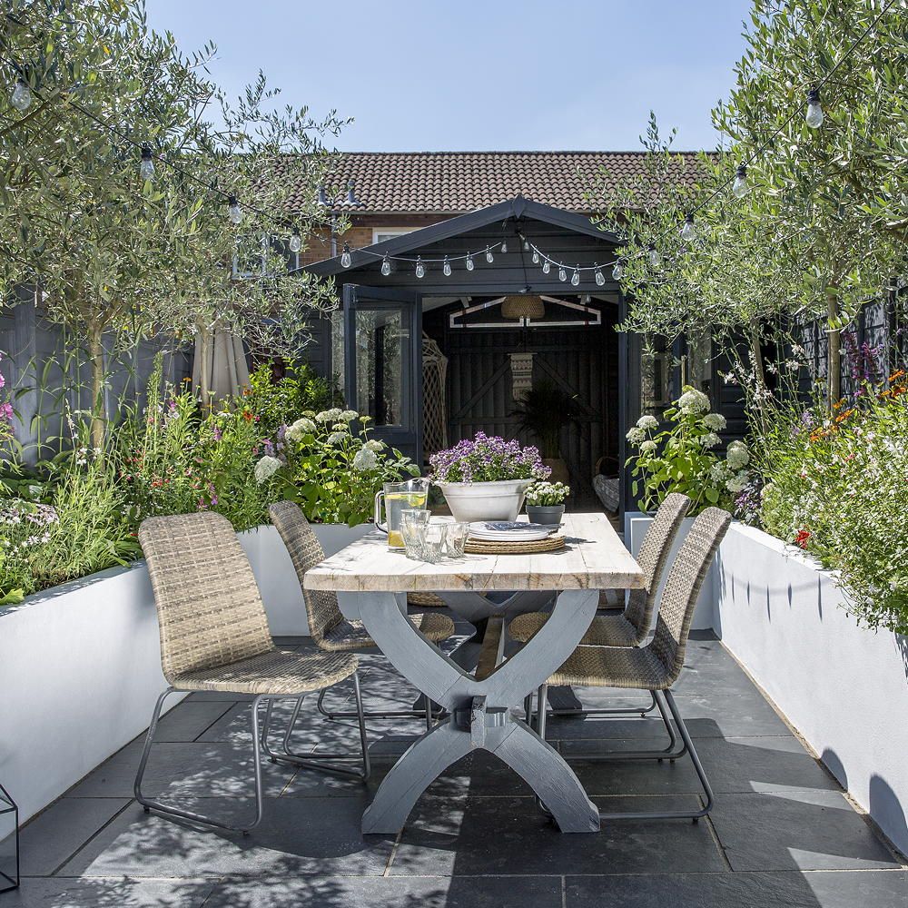 garden with wooden dinning table chair and glass door