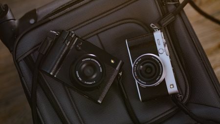 The Fujifilm X-E5 (silver) and GFX100RF (black)