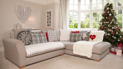 living room with christmas tree coloured cream wall sofa cushion set