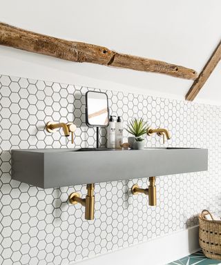 Double basin with gold taps and hexagonal tiles