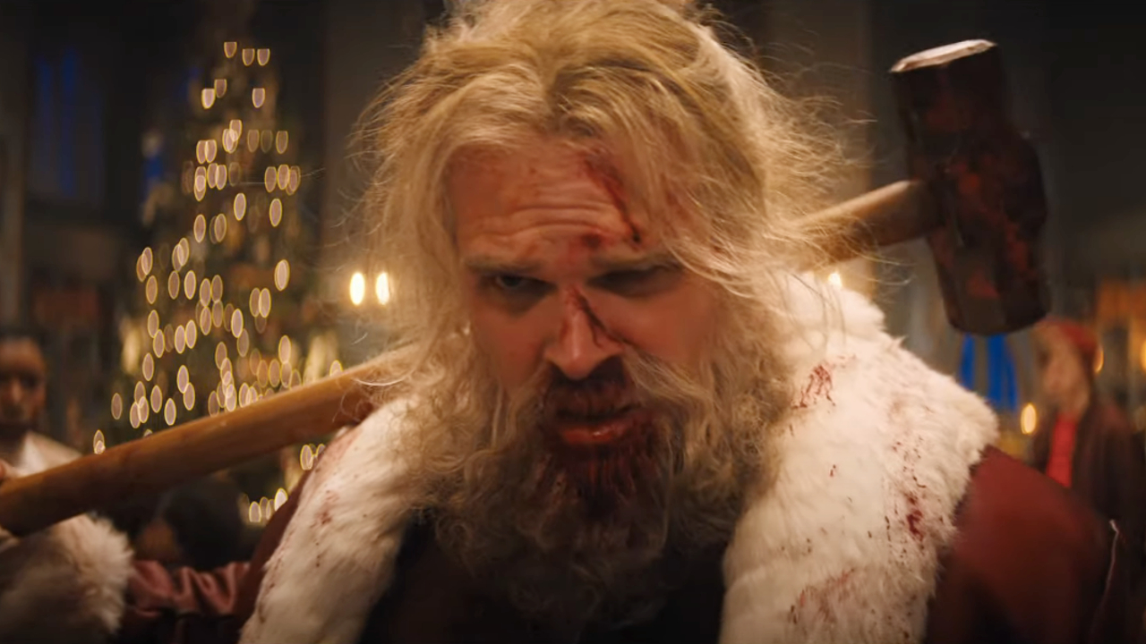 A bloodied David Harbour holding a sledgehammer in Violent Night.