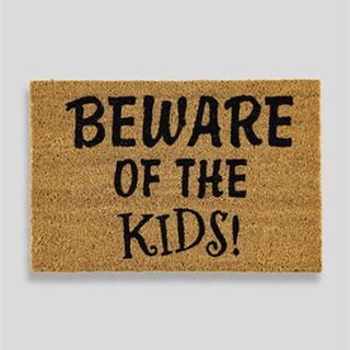 brown doormat with text beware of the kids