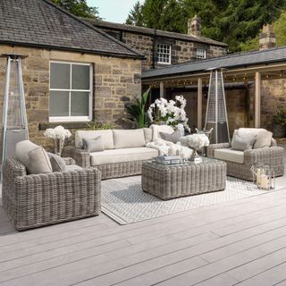 Soft grey rattan garden sofa set on decking