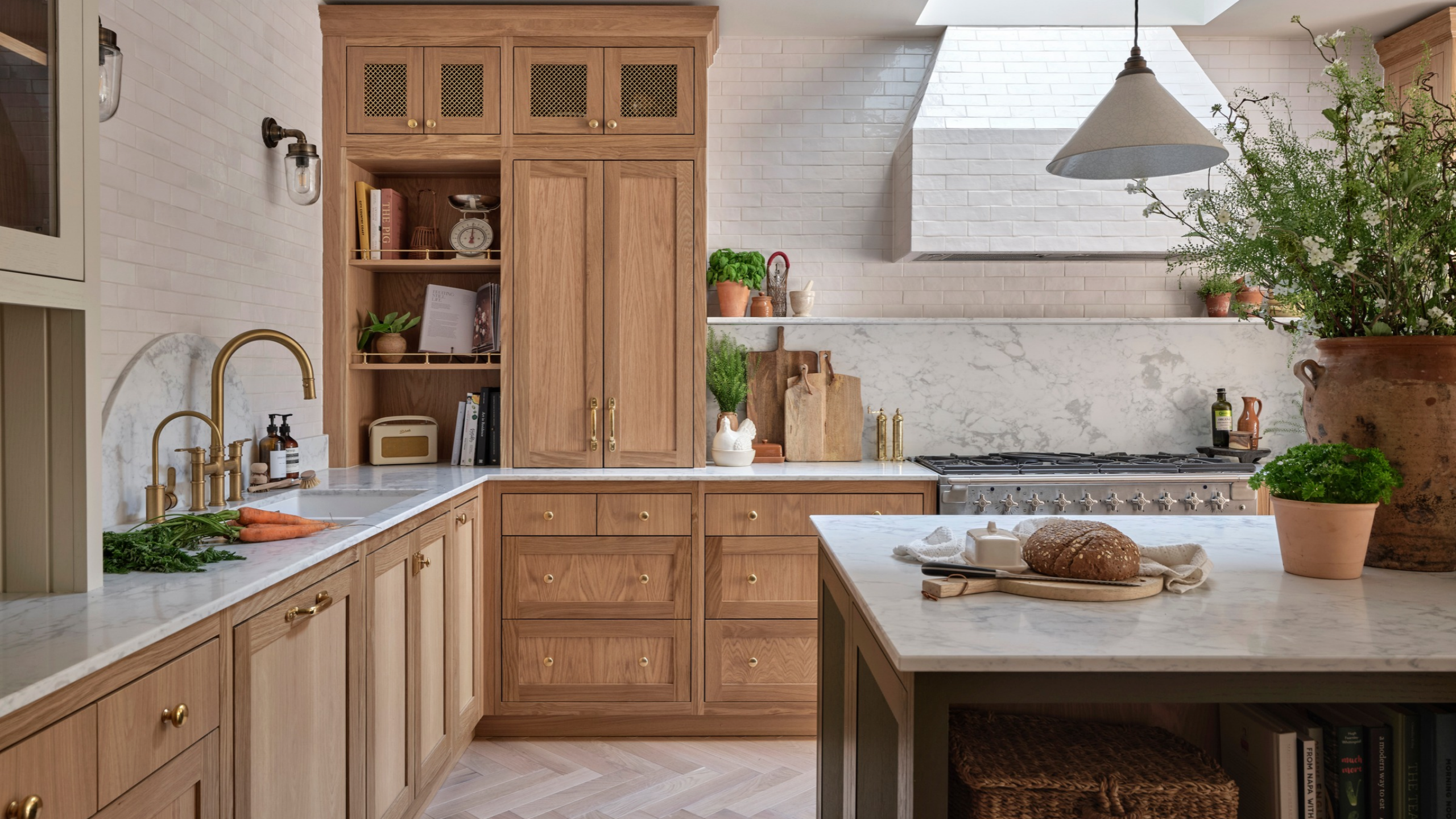 large farmhouse style kitchen with wooden cabinets, marble counters, and a tiled range hood