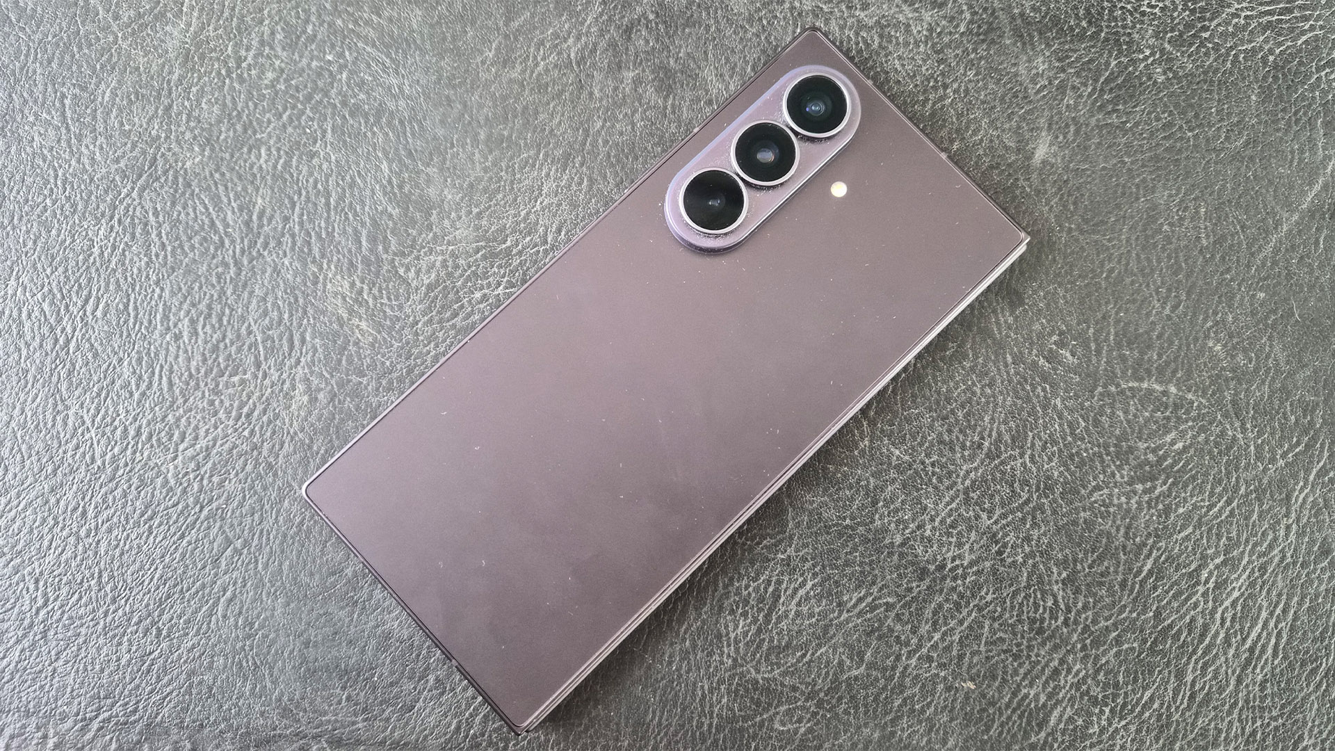Samsung Z Fold 8 Ultra smartphone face down on grey surface showing rear camera array