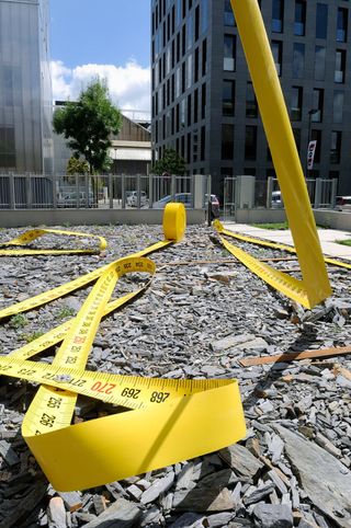 A giant tape measure laying on the ground at a construction site