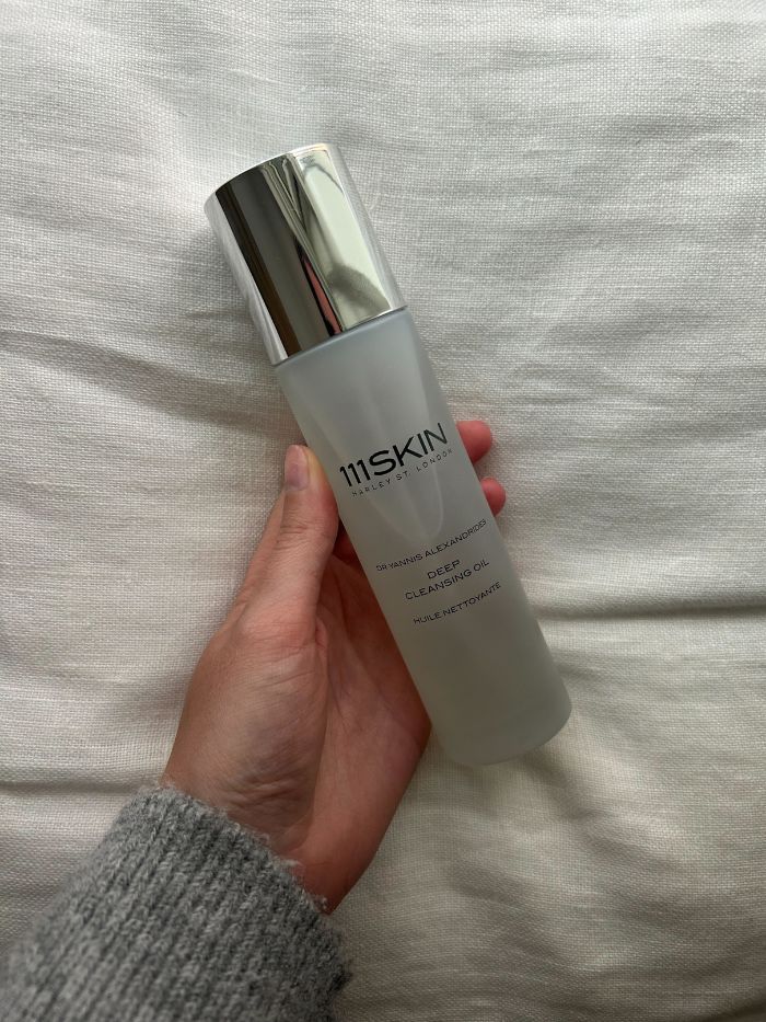 Junior beauty editor Grace Lindsay holding the 111SKIN Deep Cleansing Oil