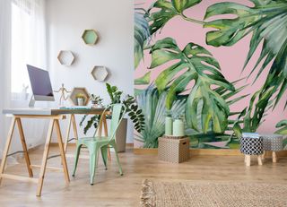 pink and tropical feature wall in an office with more simplistic, scandi style furniture