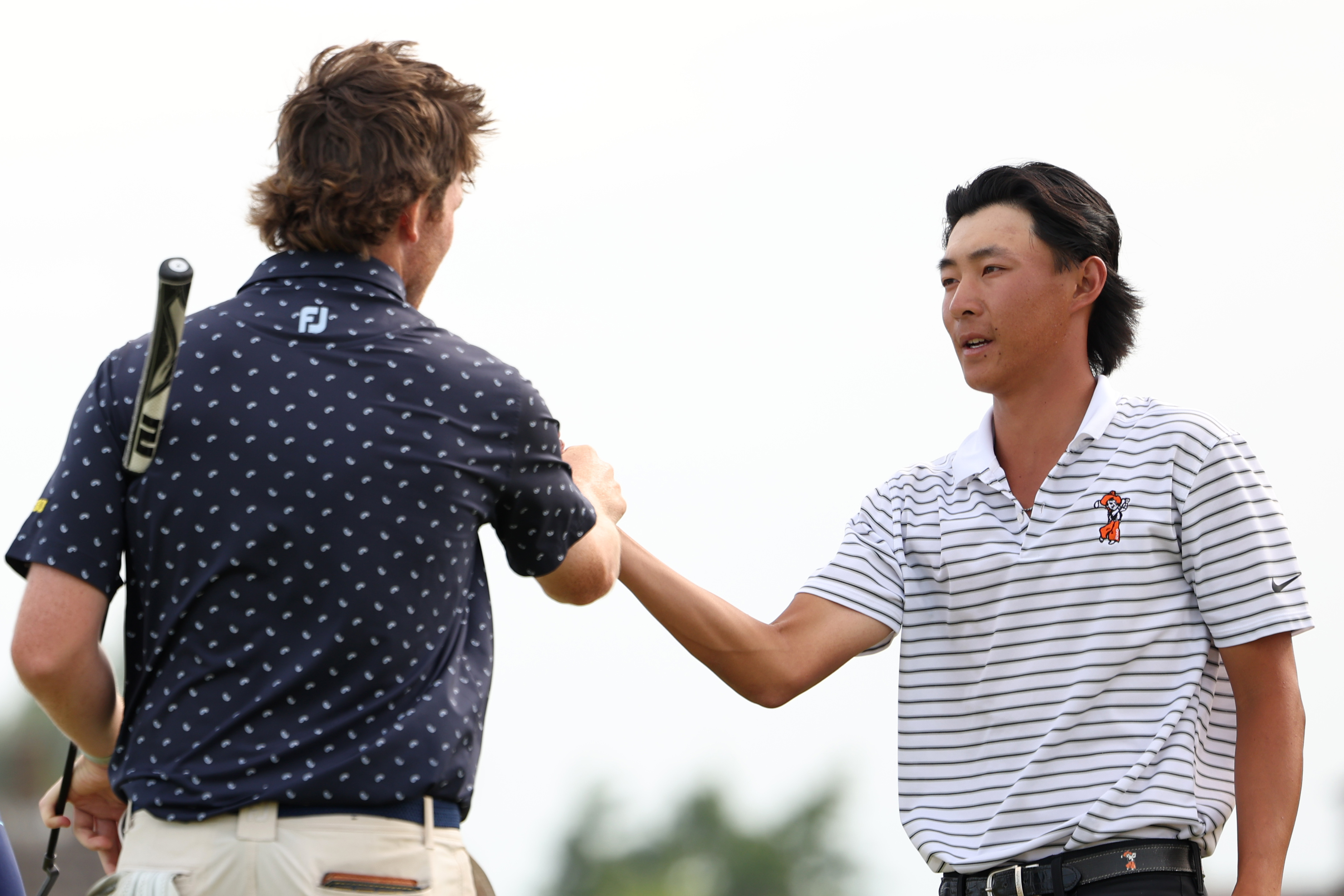 Ethan Fang shakes hands with his opponent at The Amateur Championship