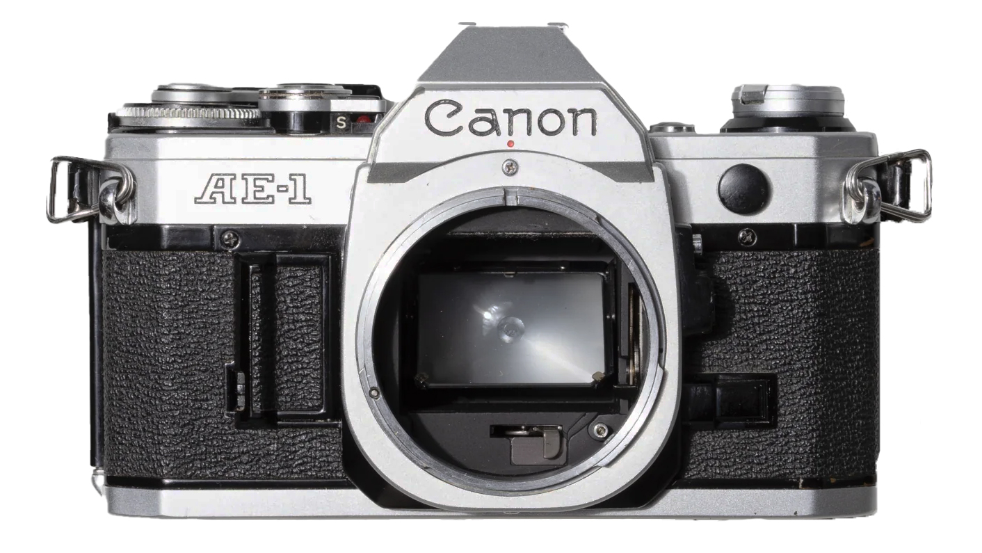 Front view of a vintage Canon AE-1 camera, featuring a silver body and black textured grip, with an open lens mount