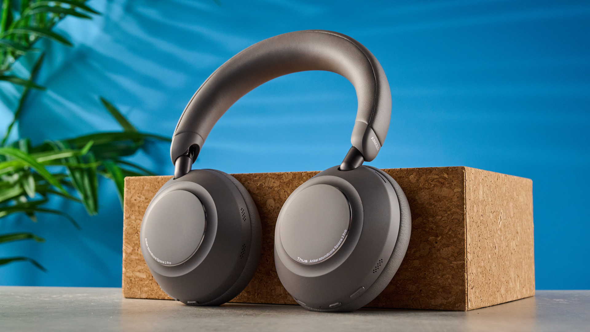 the anker soundcore space 2 pro headphones in mauve gray photographed against a blue tom's guide background