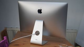 An old iMac 2020 27-inch on a table from the rear