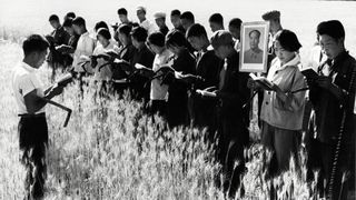 Chinese peasants meditate and read before getting to work in the fields during Mao Zedong's Cultural Revolution.