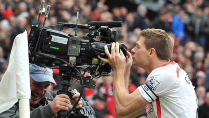 Steven Gerrard kisses a television camera 