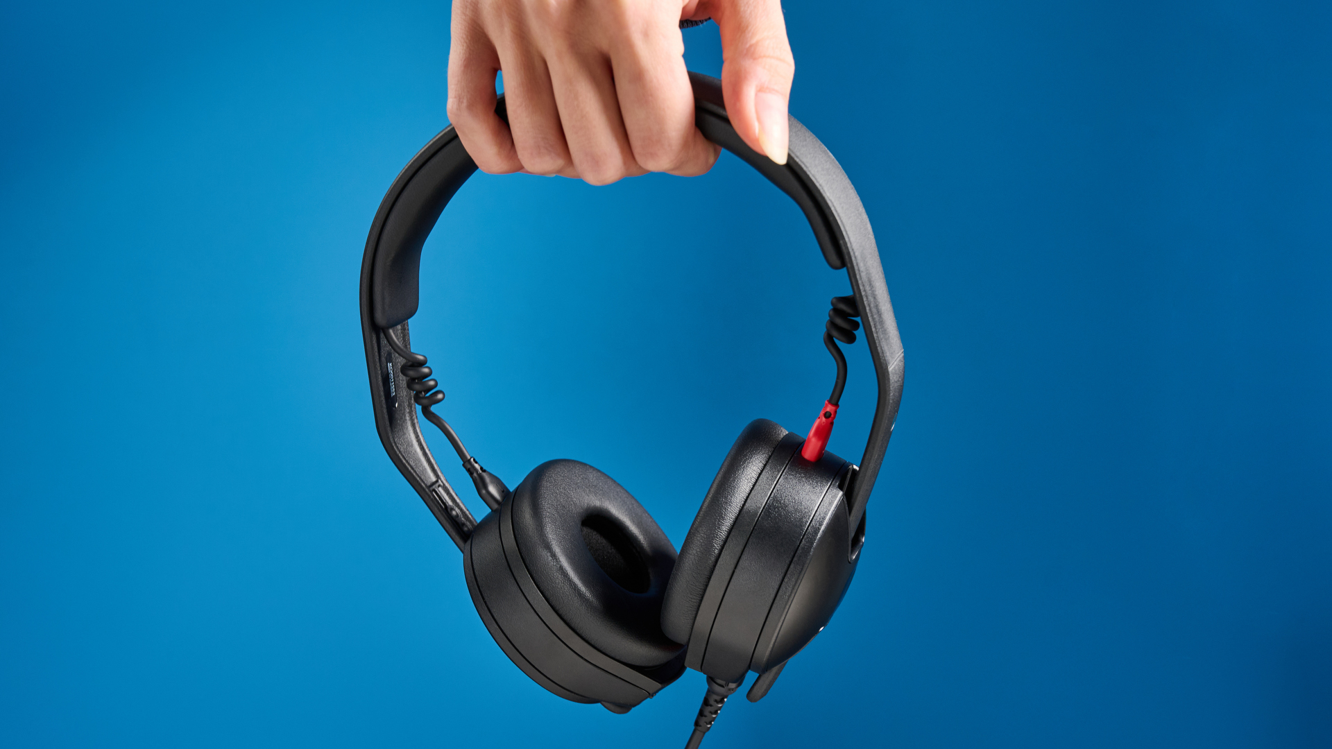 the rode nth-50 studio headphones in black showing the long cable, 3.5mm jack, 1/4 jack, and in use