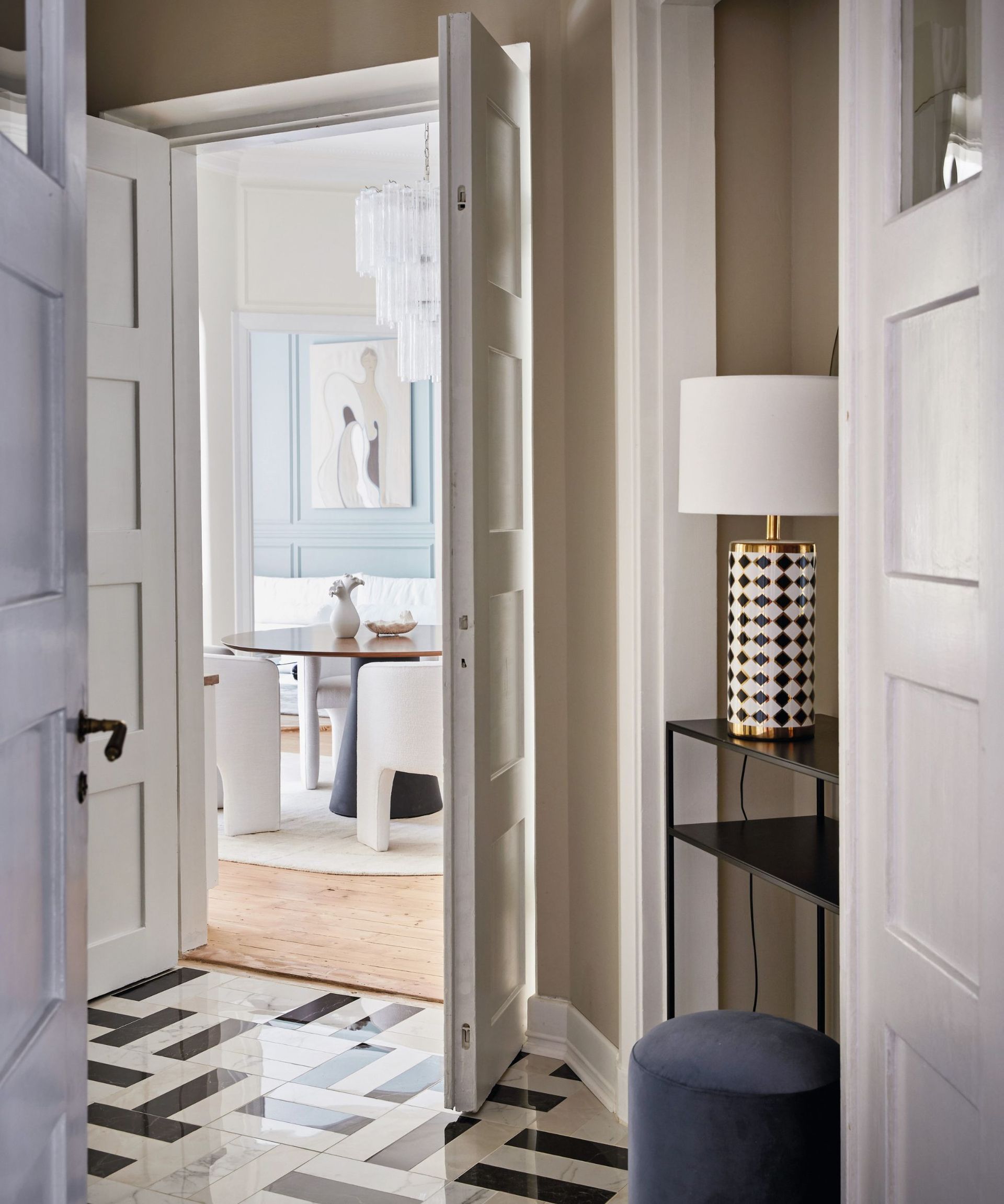 Black and white tiled floor, blue stool