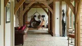 oak frame interior with bucket seat hanging from beams
