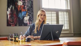 woman at desk with tablet PC on table