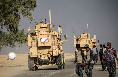 An armored vehicle with an American symbol on it drives near Mosul on Oct. 18.