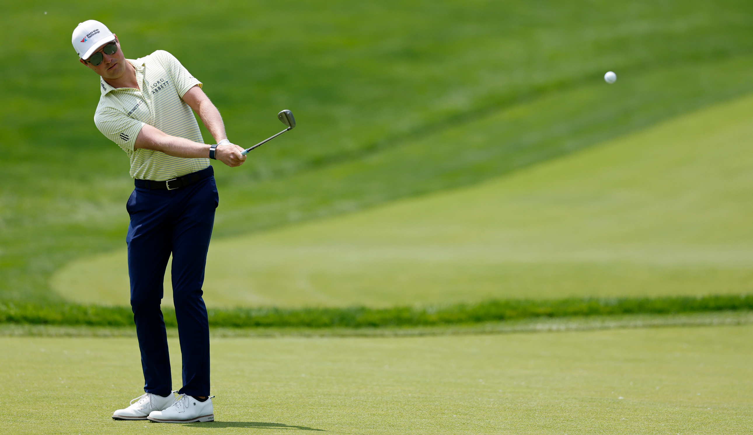 Ben Griffin hits a wedge shot from the fairway