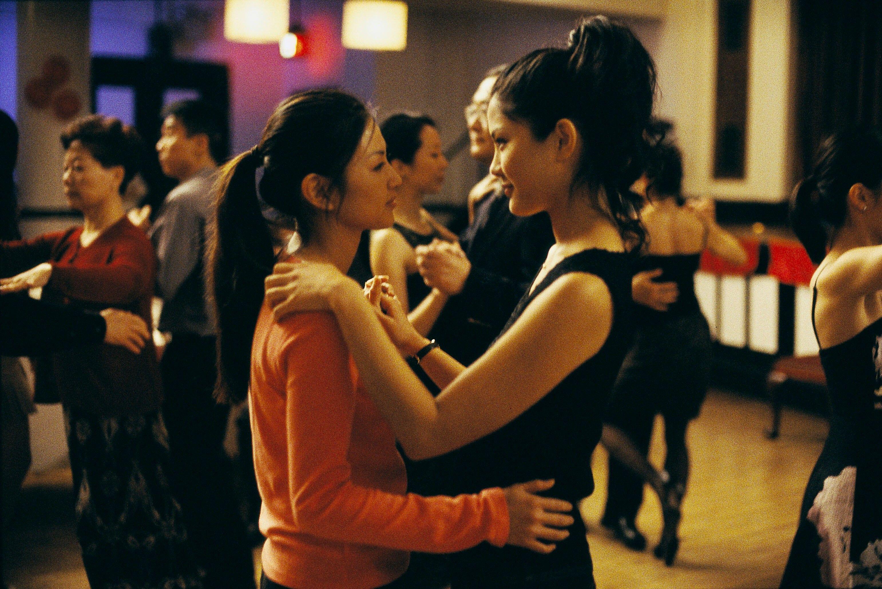 two women dancing at an event in the movie saving face