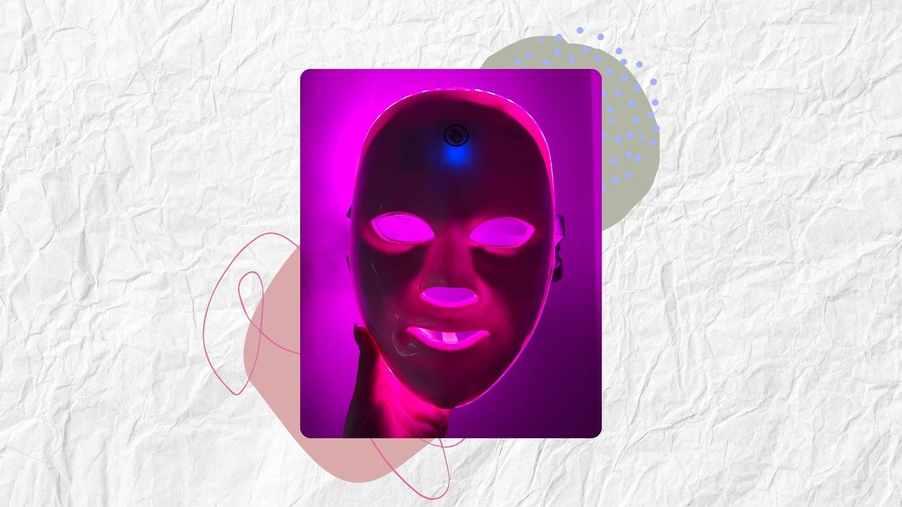 Image of a hand holding the Boots LED Face Mask with the pink light on, on a white textured background with pink and green details