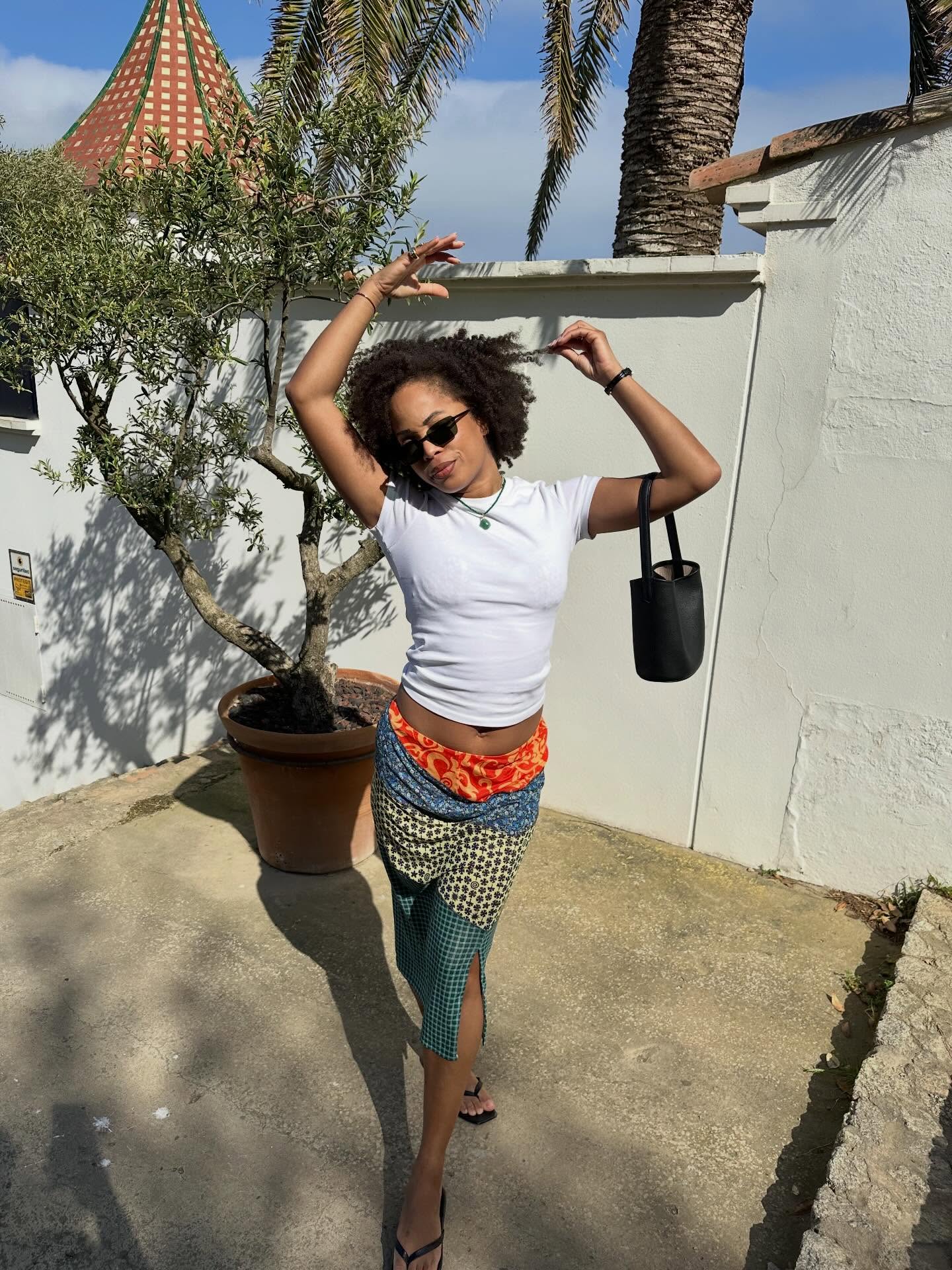 An image of a woman wearing summer knee length skirt outfit 2026