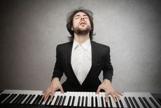 man in tuxedo playing piano