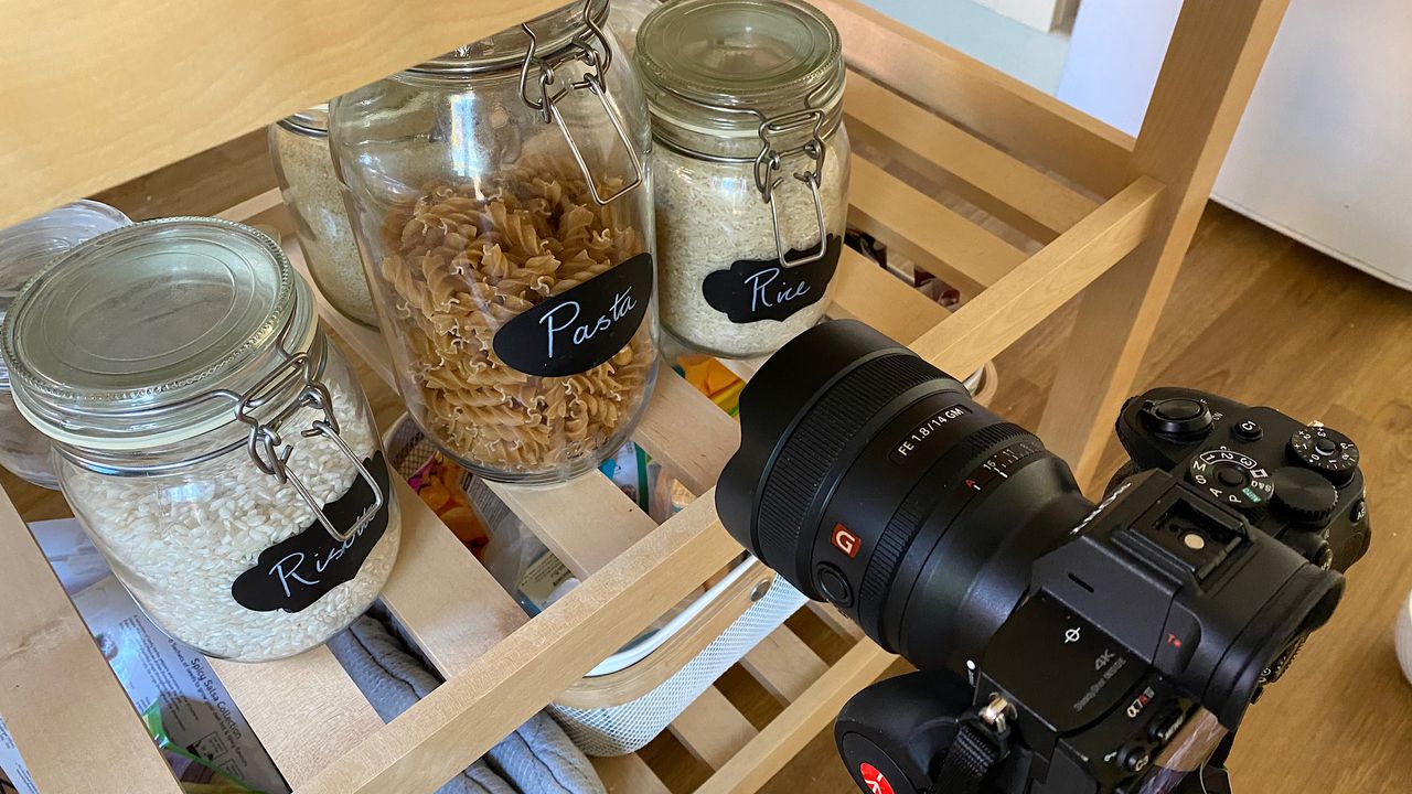 A set up showing the camera taking photographs of pasta in jars
