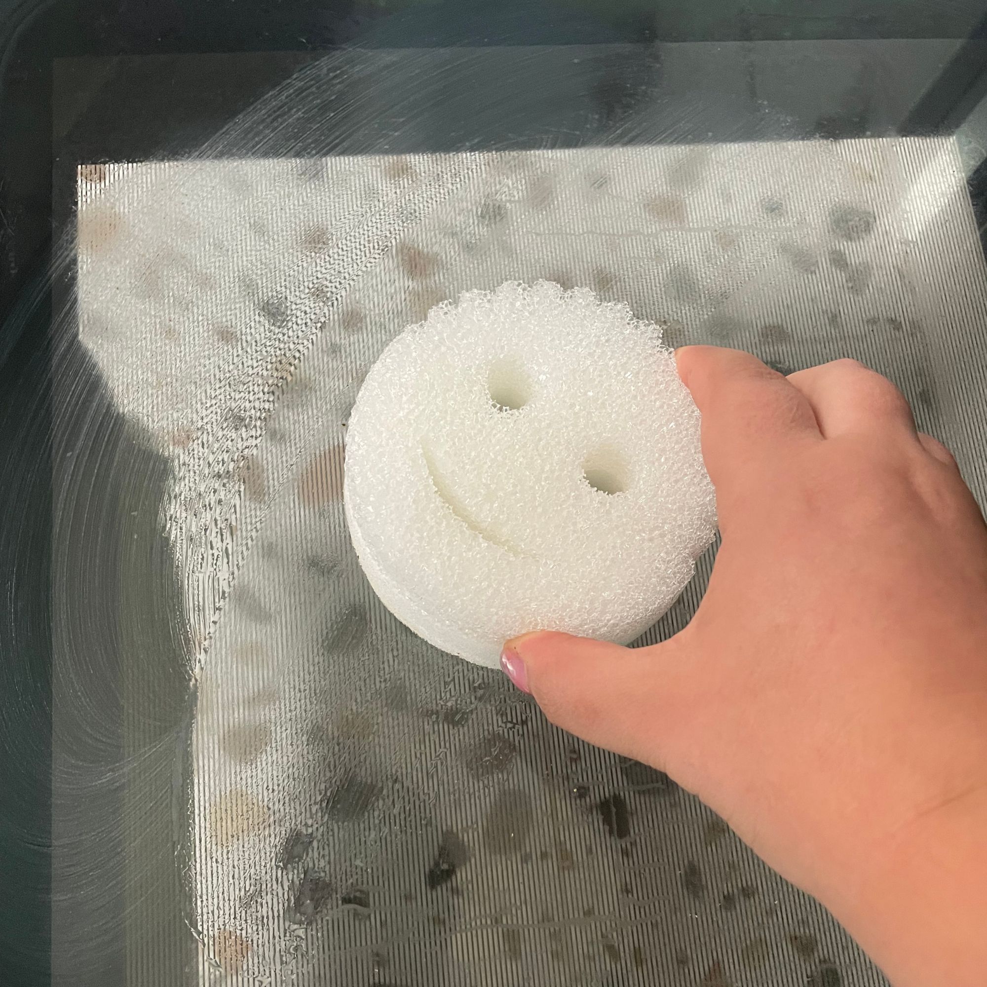 Using the Scrub Daddy Power Paste Multi Purpose Cleaner on an oven door
