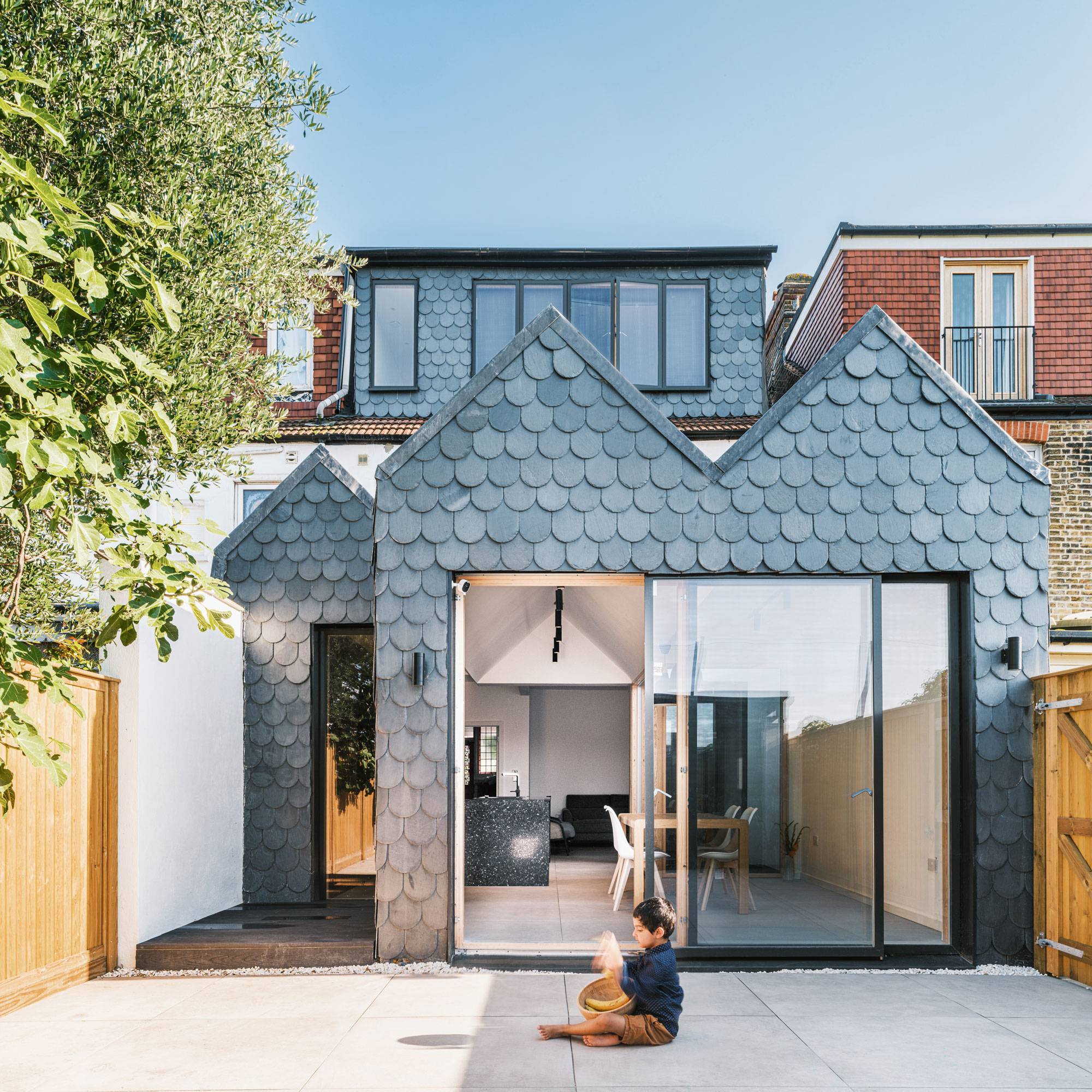 exterior image of an extension covered in fish scale slate tiles