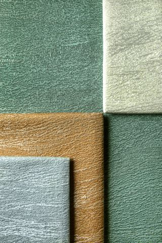 A close-up of the textured fabric in different colors, folded in a square shape.