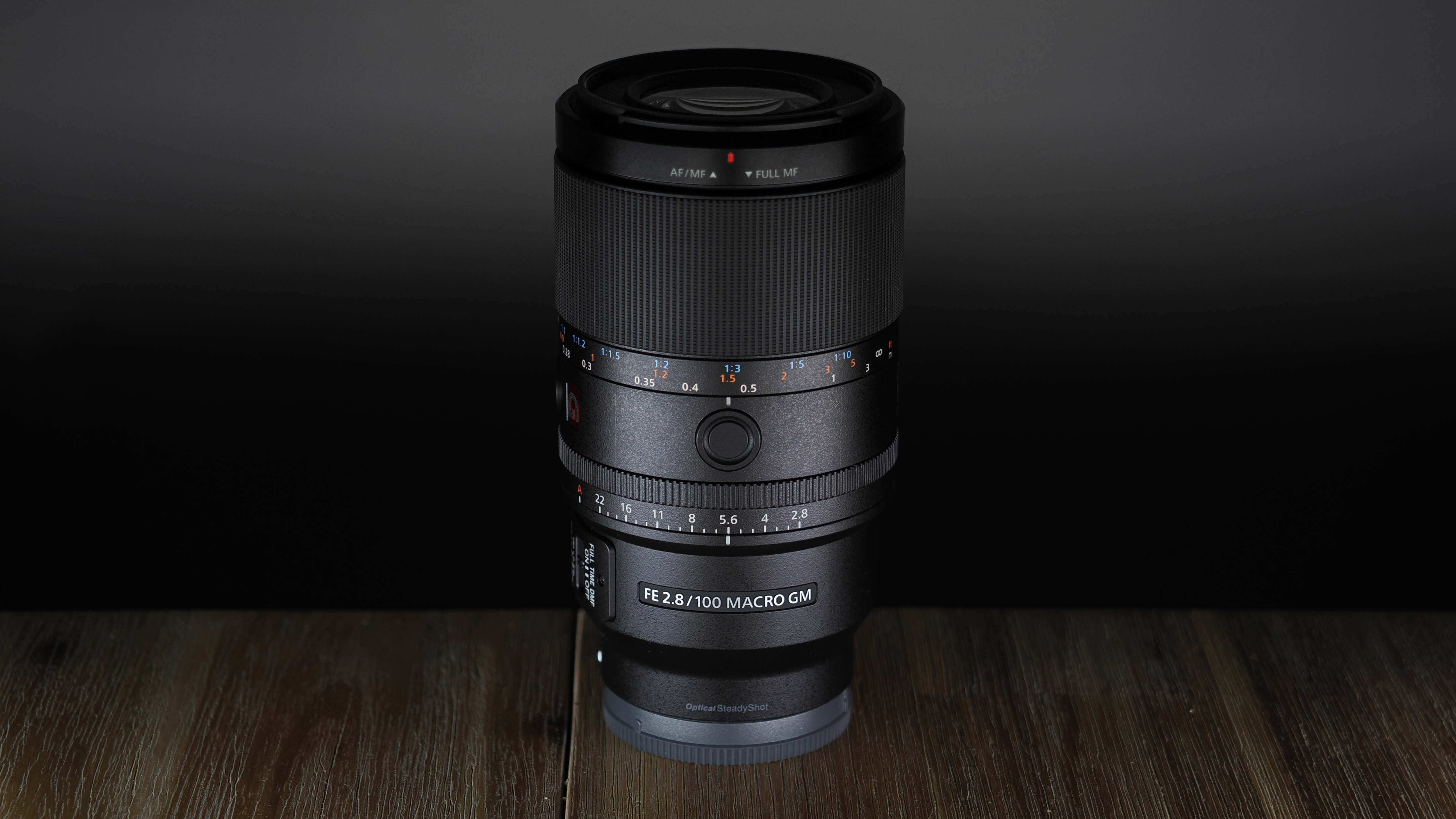 Sony FE 100mm f/2.8 Macro GM OSS on a wooden surface