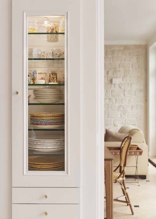 country kitchen diner with cream colored tall cabinet for china