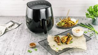 ZWILLING air fryer in a modern kitchen on the countertop, with air fryer cooked chicken on a plate
