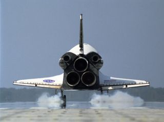 Seen from behind, space shuttle Discovery kicks up dust as it touches down on Runway 33 of the Shuttle Landing Facility at NASA's Kennedy Space Center to complete the 15-day mission STS-120 on Nov. 7, 2007.