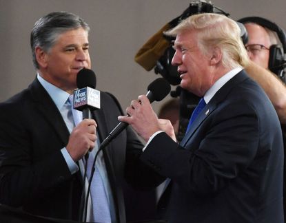Fox News Channel and radio talk show host Sean Hannity (L) interviews U.S. President Donald Trump before a campaign rally at the Las Vegas Convention Center on September 20, 2018 in Las Vegas