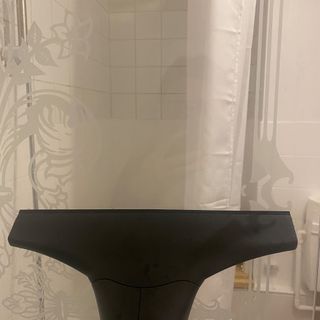 Image of window vacuum being used to clean shower glass in bahtroom