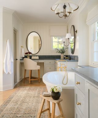 bathroom with roll-top bath and traditional rug