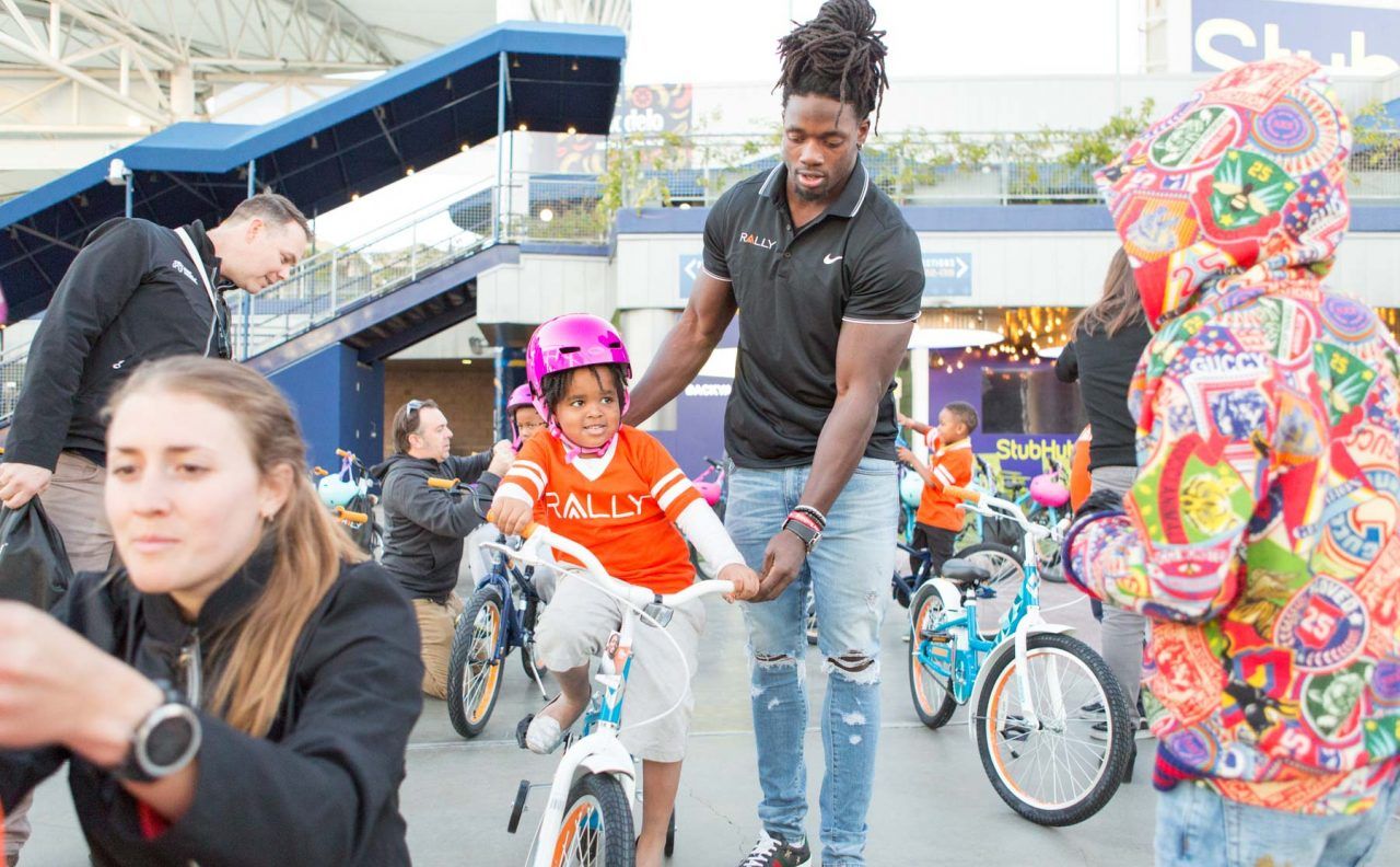 Melvin Gordon help one of the kids go for a spin