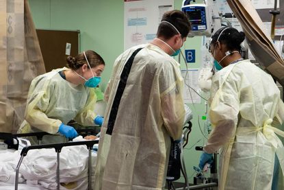 Sailors assigned to the hospital ship USNS Mercy (T-AH 19) treat the first patient from Los Angeles medical facilities March 29