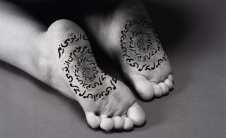 Shirin Neshat black and white photograph of henna-ed feet
