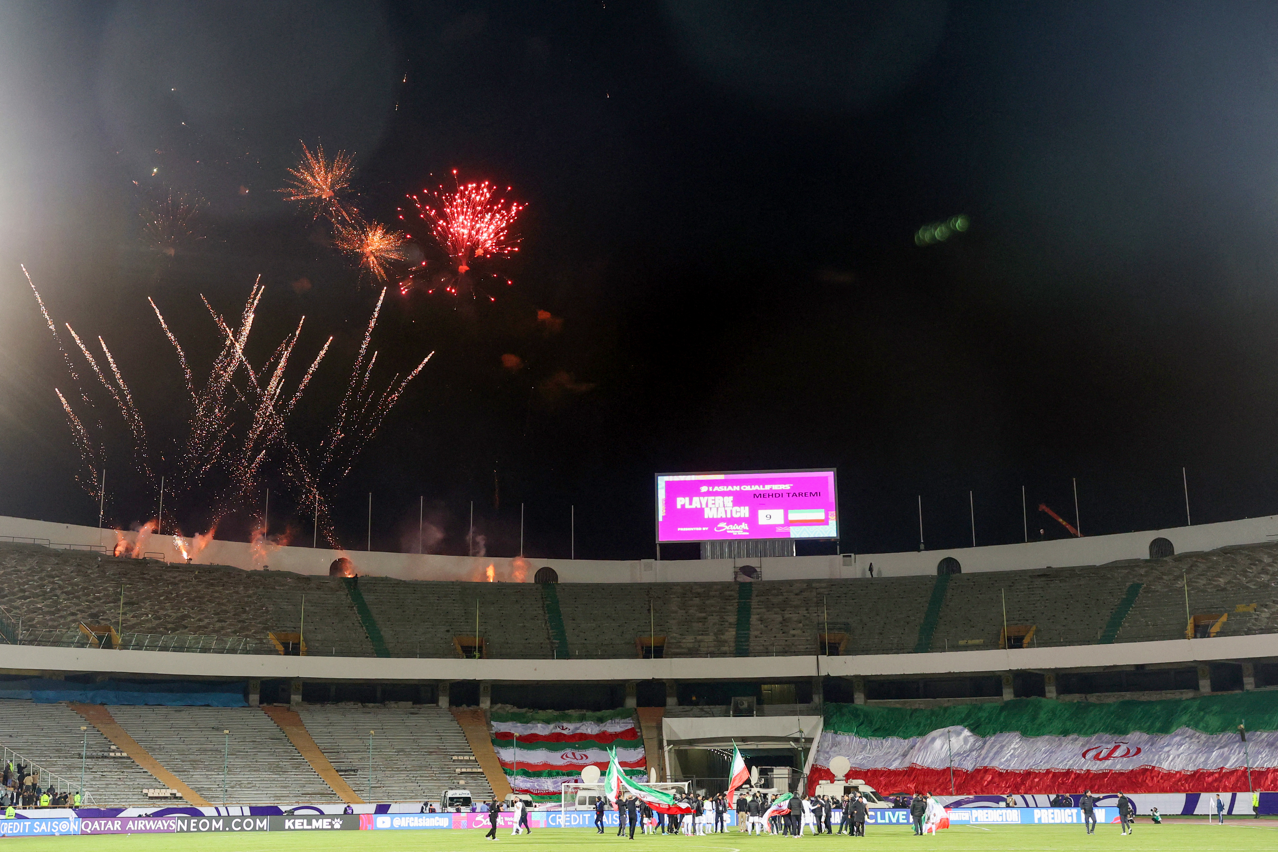 Iran&#039;s team members celebrates as fireworks explode after the FIFA World Cup 2026 Asian zone Group A qualifier between Iran and Uzbekistan at Azadi Stadium in Tehran on March 25, 2025. (Photo by AFP)