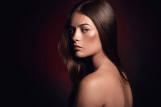 A female model lit by strobes in the studio