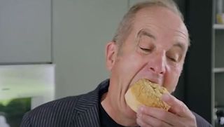 Kevin McCloud eating a cronut